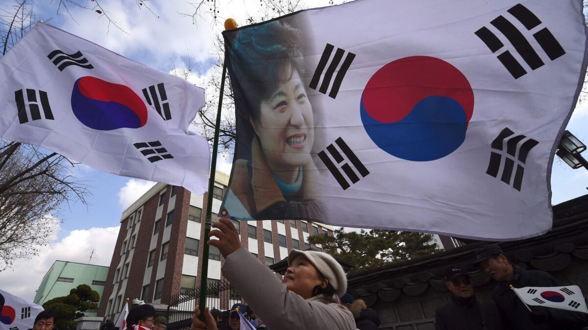 A supporter of South Korean President Park Geun-Hye rallies in Seoul in opposition to her impeachment on Thursday.