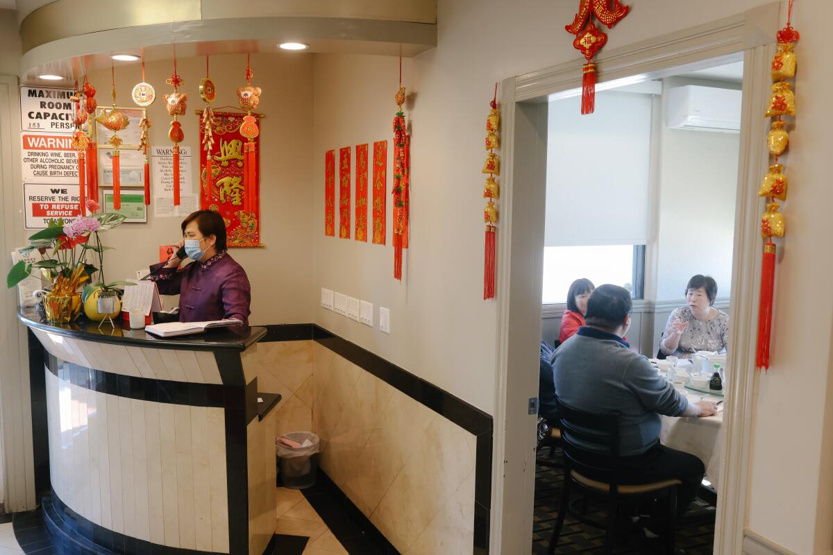 Lina Situ, co-owner of Taste of MP, answers the Monterey Park eatery's phone on Tuesday.