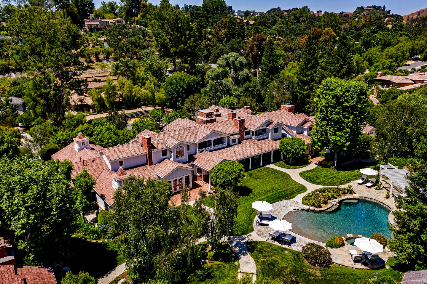 HIGH $27.5 million The 2.6-acre spread includes two homes that combines for 21,000 square feet, a backyard with a pool and horse facilities, and a sports facility with a gym, racquetball court, batting cage, tanning room and 150-person party room.