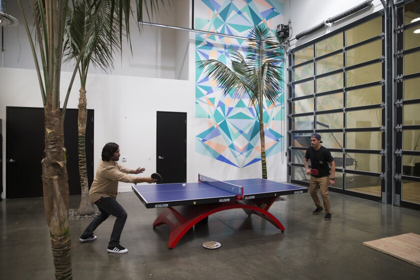 Employees play ping pong during an encouraged break from work at sock brand Stance’s headquarters in San Clemente on Oct. 1, 2015.