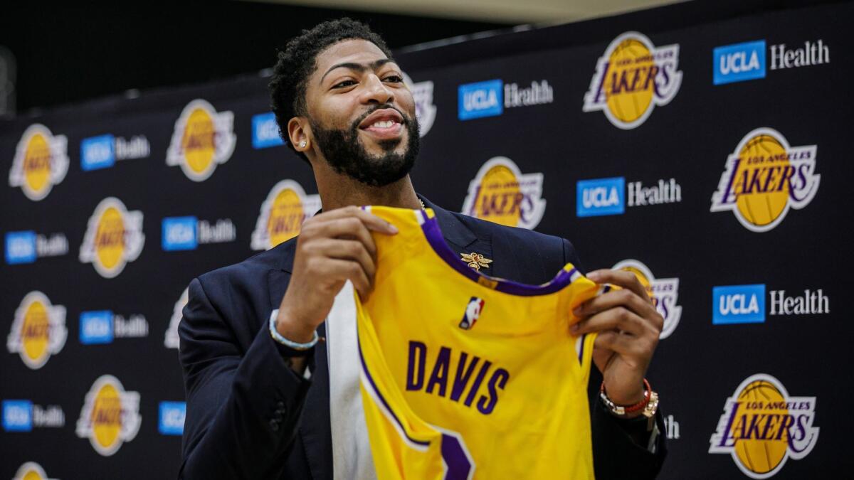 Anthony Davis displays his Lakers jersey during his introductory news conference Saturday.