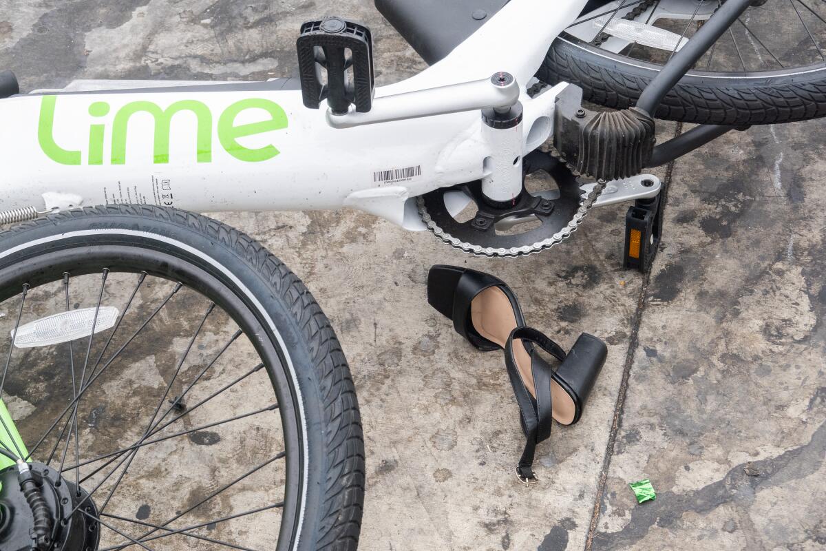 A blank shoe and pulled in the electrical bicycle in front of Vermont Club in Los Angeles