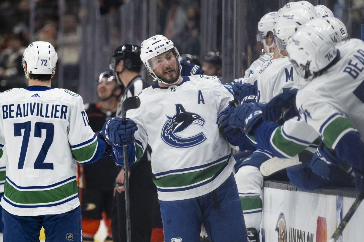 Vancouver Canucks center J.T. Miller (9) celebrates after his goal with his teammates during the first period of an NHL hockey game against the Anaheim Ducks in Anaheim, Calif., Sunday, March 19, 2023. (AP Photo/Kyusung Gong)