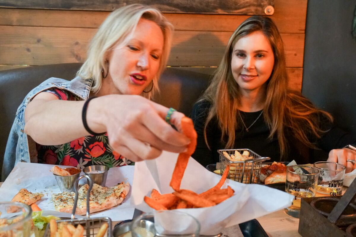 Heidi Redlitz of Hillcrest, left, took a ProTaste dining tour of Pacific Beach in May with her friend Ali Edelman.