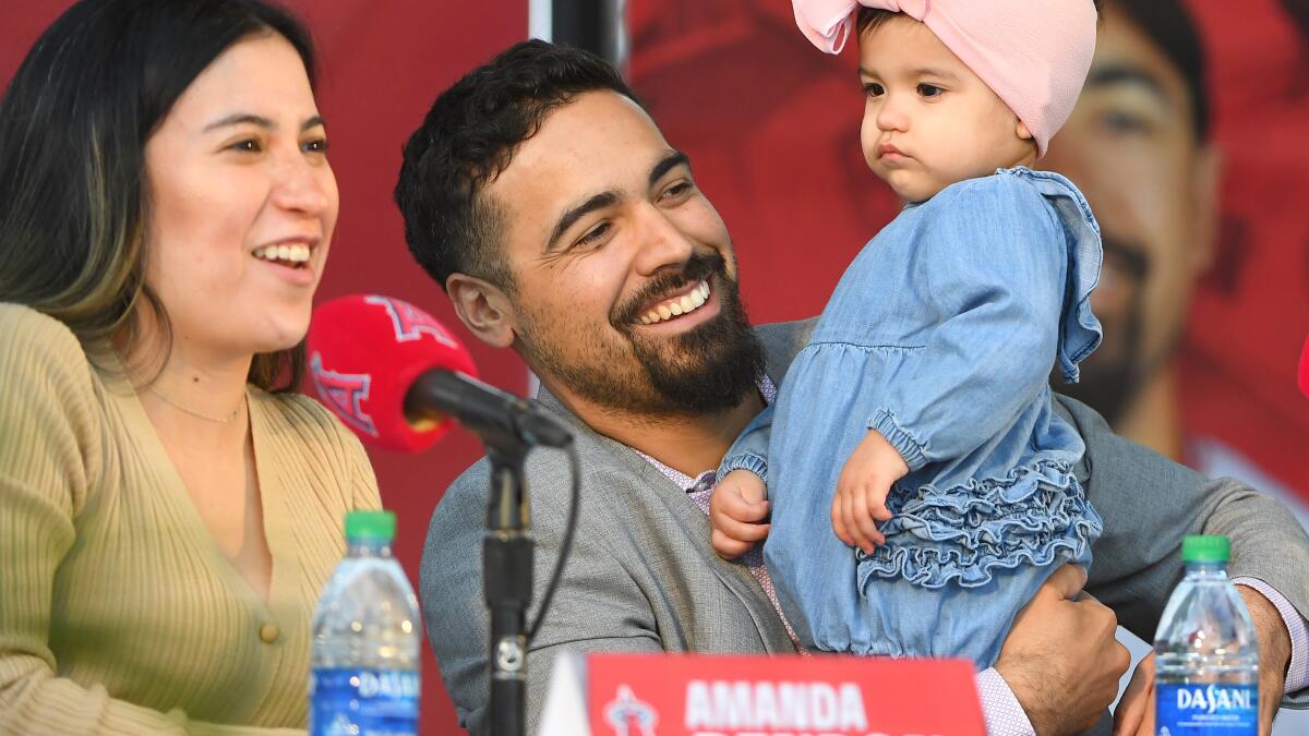 Anthony Rendon looks over with his daughter, Emma, during a news conference  to introduce Rendon as the newest Los Angeles Angels baseball player in  Anaheim, Calif., Saturday, Dec. 14, 2019. Rendon and