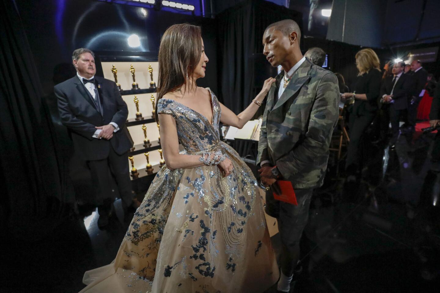 Presenters Michelle Yeoh and Pharrell Williams backstage.