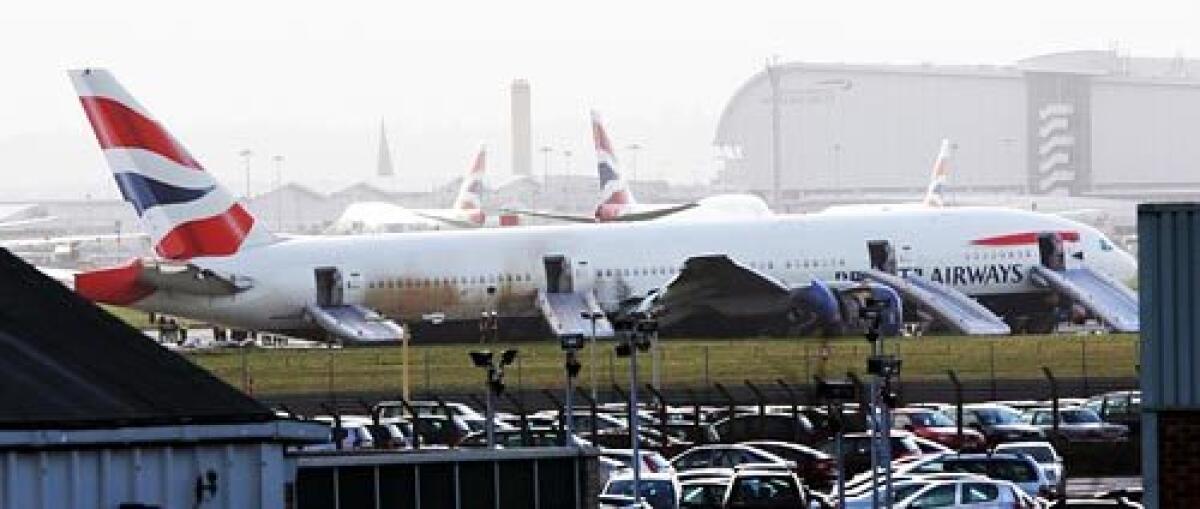 Emergency chutes are deployed on a British Airways Boeing 777 that landed short of the runway at London's Heathrow Airport. All passengers aboard Flight 38 from Beijing were evacuated and no one was seriously hurt, officials said.