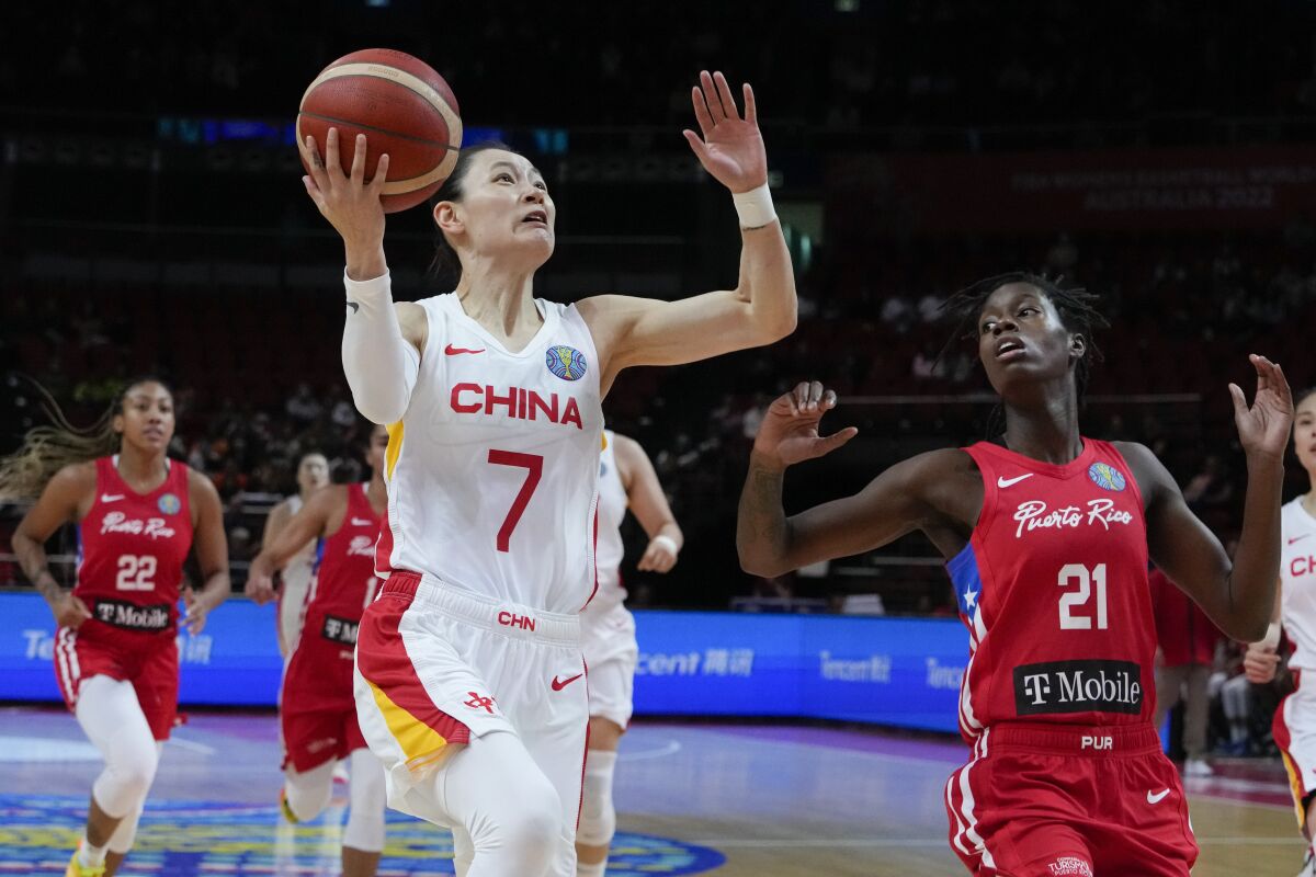 China's Yang Liwei elevates for a layup against Puerto Rico's Mya Hollingshed during a FIBA Women's World Cup game.