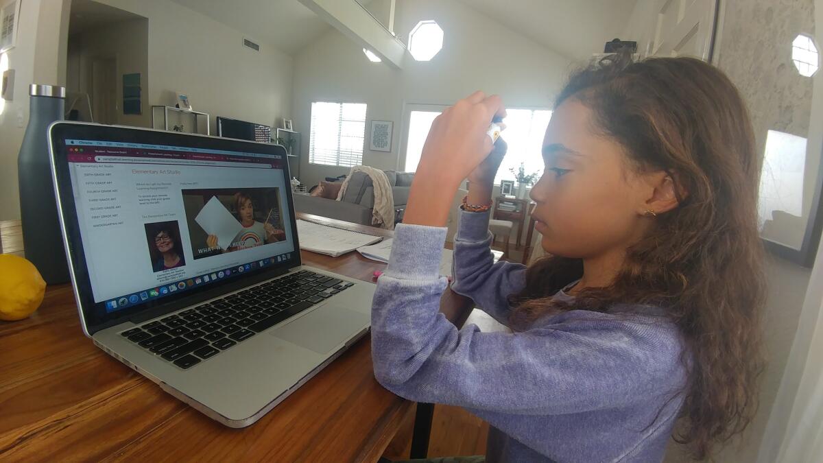 Parker Curry, 10, of Los Angeles uses a laptop to do her schoolwork online.