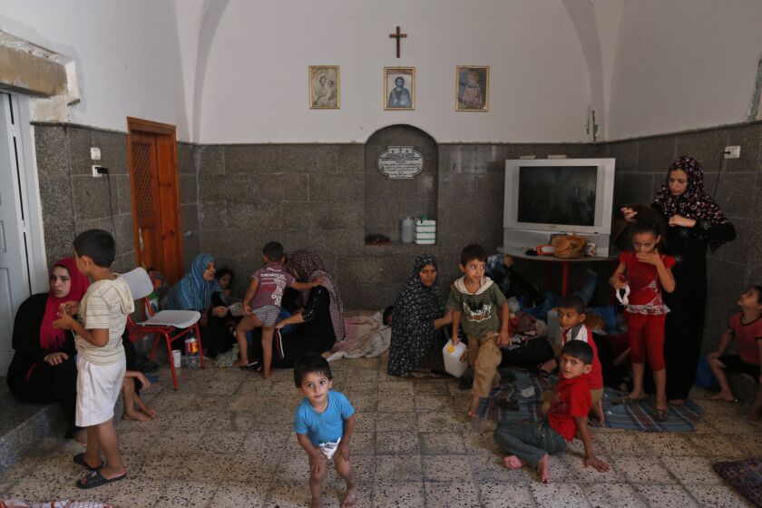 Palestinians seek refuge on July 23 inside St. Porphyrios Church in Gaza City. Entire families are sleeping on thin sheets on the hard church floors.