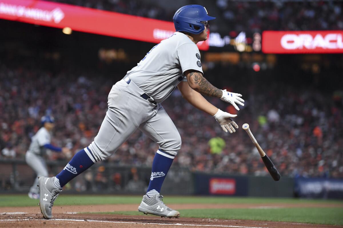 Dodgers batter Julio Urías hits a run-scoring single in the second inning against the Giants.