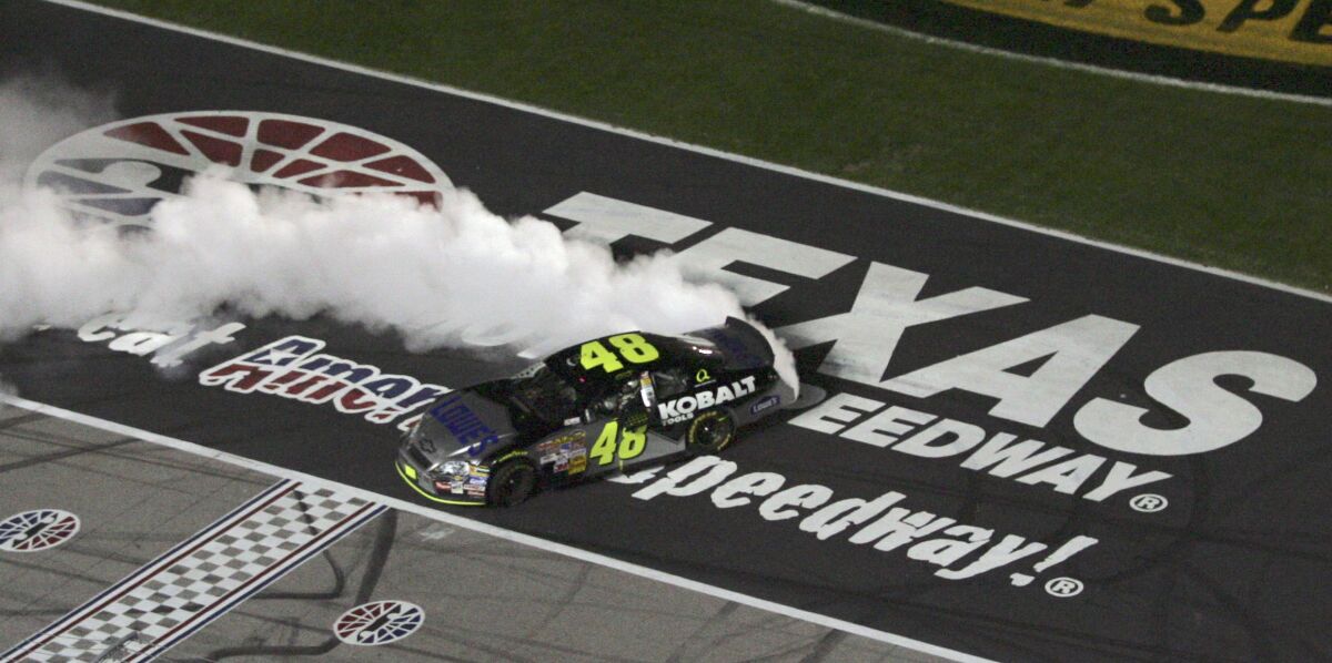 NASCAR driver Jimmie Johnson celebrates after winning the NASCAR Cup Series Dickies 500 auto race at the Texas Motor Speedway, Nov. 4, 2007, in Fort Worth, Texas. A record seven wins, the most laps led in Texas Motor Speedway history and a resume so stout they renamed victory lane after him. But as Jimmie Johnson prepares for his IndyCar debut at the track he dominated for a decade he has low expectations of earning a trip to “the Jimmie Johnson Winners Circle." Johnson will race Sunday, March 20, 2022 at Texas in his first oval race as an IndyCar driver. (AP Photo/Tim Sharp)