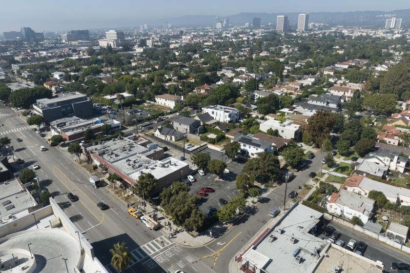 LOS ANGELES, CA - October 18: The city proposed a 33-bed interim homelessness shelter at a current parking lot, lower center, at Midvale Avenue and Pico Boulevard in Los Angeles. The project will provide onsite laundry, housing units with ensuite bathrooms and services for people experiencing homelessness. Some neighbors oppose the project arguing that it will be too close to residential areas. Photographed in Westside on Wednesday, Oct. 18, 2023 in Los Angeles, CA. (Myung J. Chun / Los Angeles Times)