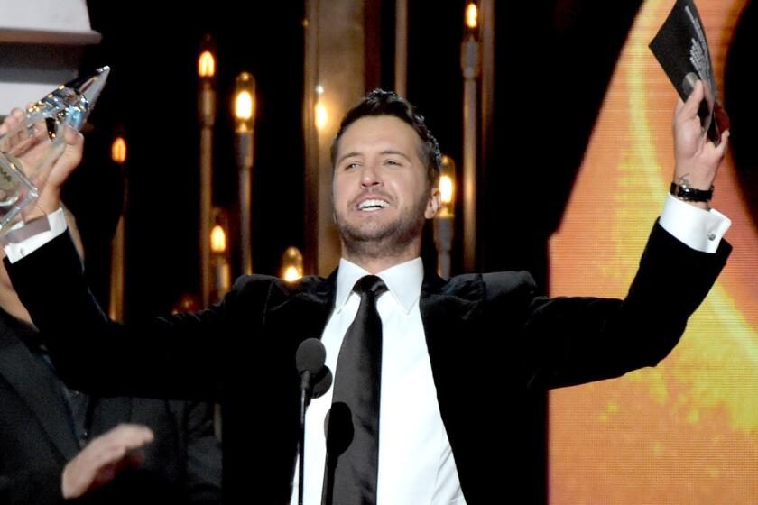 Luke Bryan accepts the award for Entertainer of the Year during the 48th CMA awards.