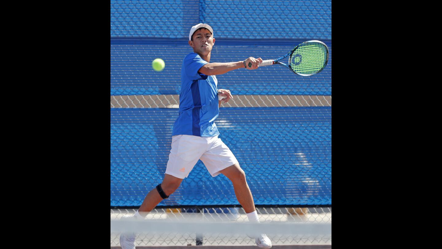 Fountain Valley High's Justin Nguyen follows through with a forearm shot during a No. 1 singles set against Los Alamitos in a Sunset League match on Tuesday, April 17.