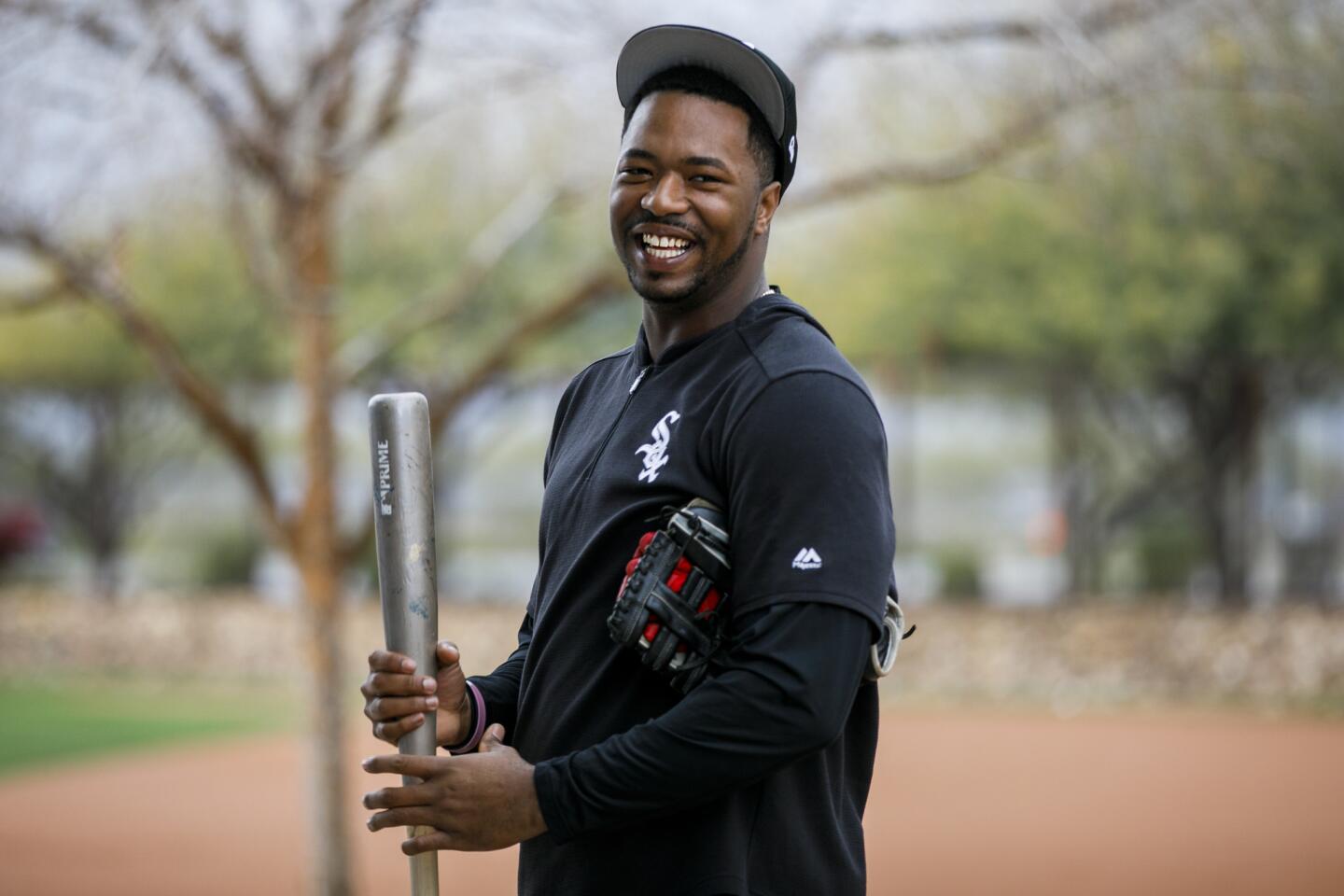 Eloy Jimenez stands near a batting cage during White Sox spring training at Camelback Ranch on Feb. 21, 2019.