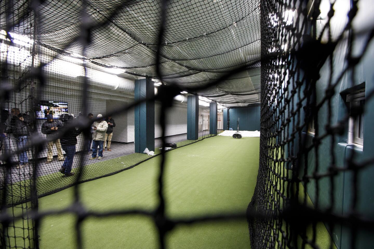 Expanded batting cage for visiting team