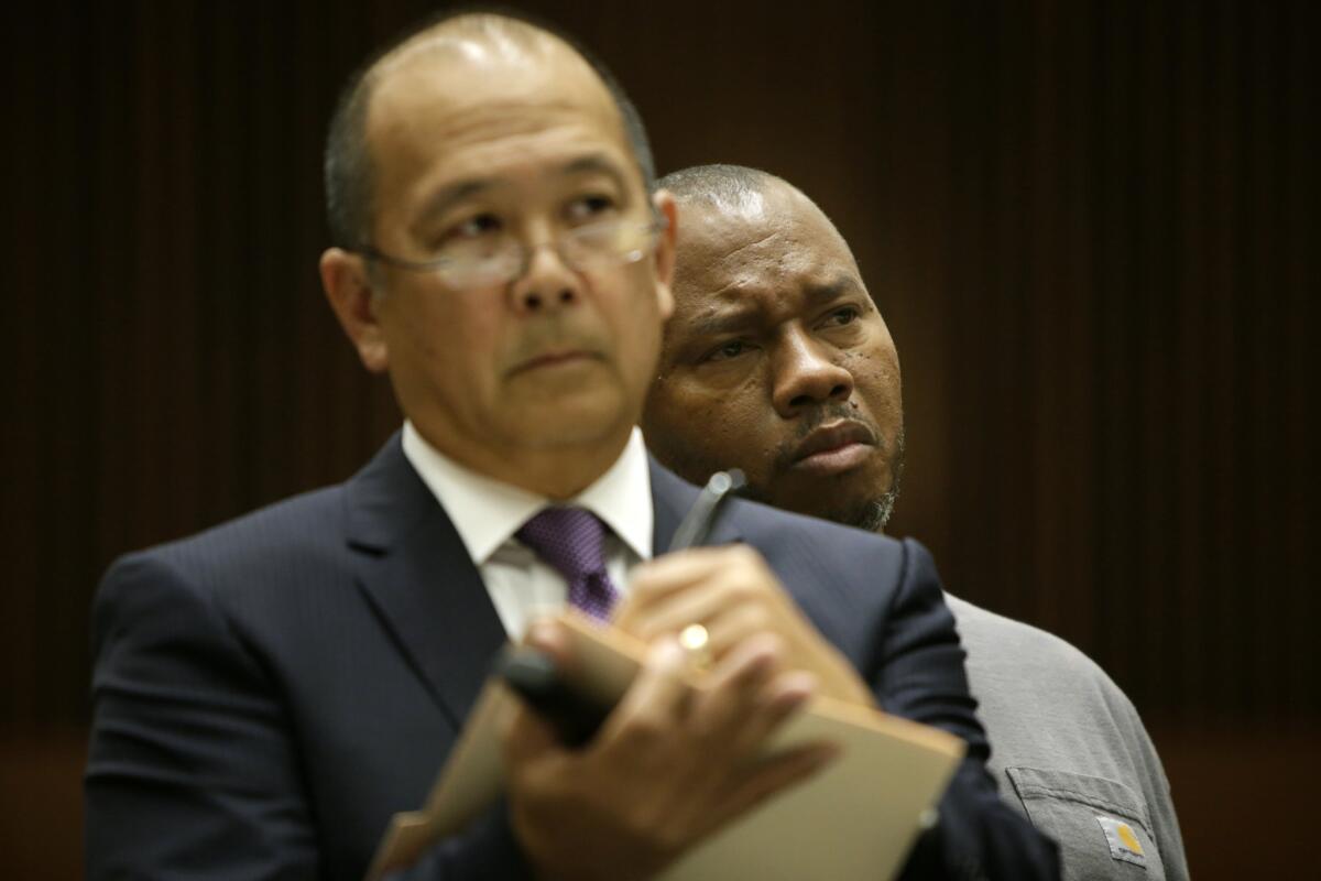 LAPD detective Oris Pace, right, standing behind his attorney, Bill Seki, was sentenced Friday to 180 days in jail and must resign from the force for assaulting three women.