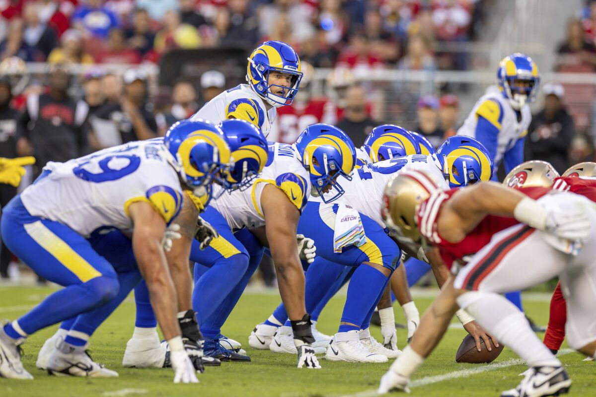 Rams quarterback Matthew Stafford stands behind center against the San Francisco 49ers.