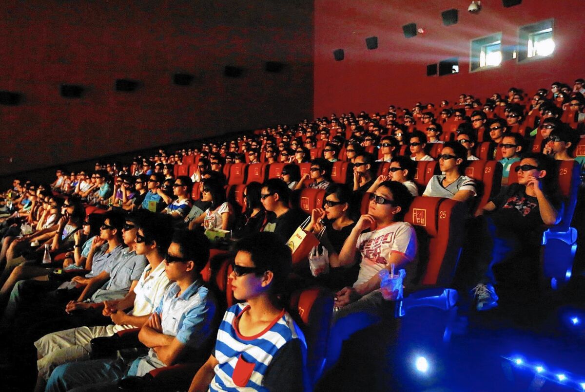Hollywood executives have learned to greet news of a partnership with Chinese firms with a degree of skepticism. Above, audiences in China watch a 3-D showing of “Transformers: Age of Extinction.”