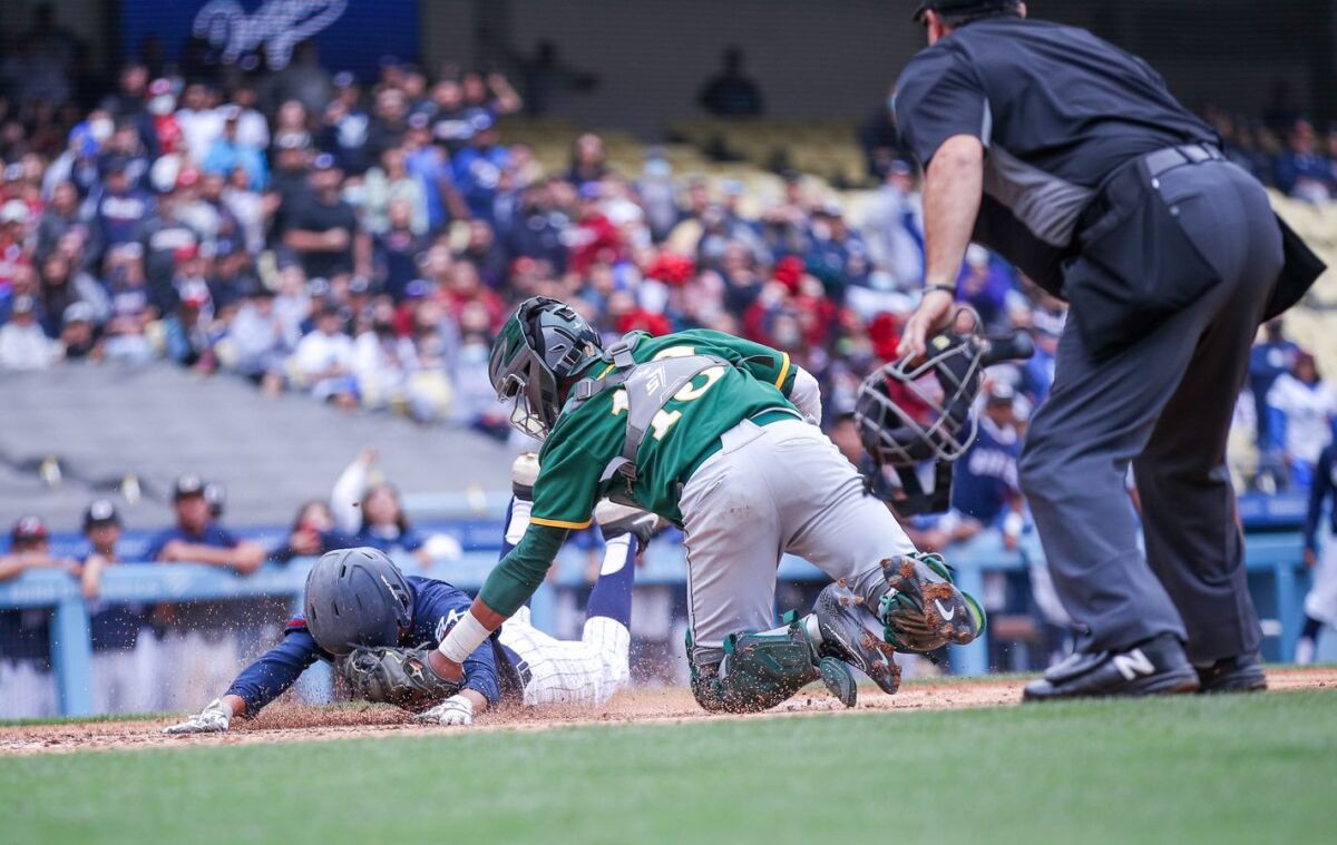 In a close play at the plate, catcher Jaylen Thomas of Narbonne tags Daniel Canales of Garfield.