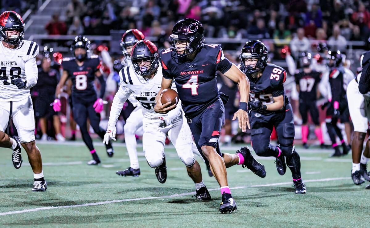 Quarterback Husan Longstreet of Corona Centennial takes off on a run against Murrieta Valley.