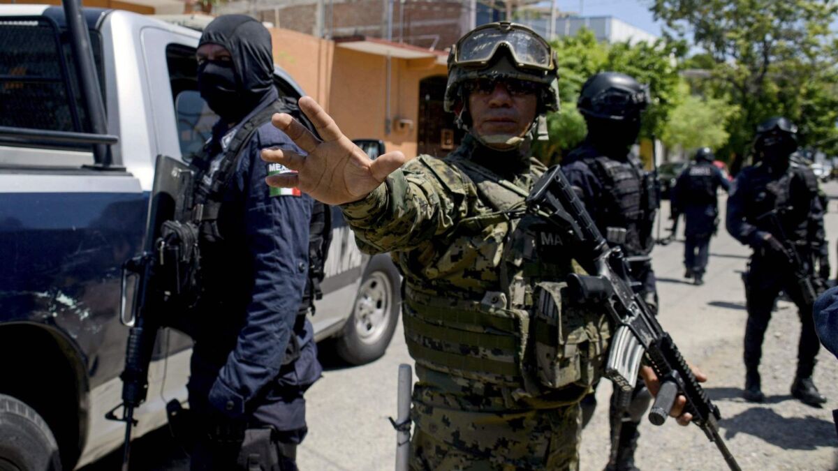 Mexican navy members and federal police take part in an operation in Acapulco on Sept. 25, 2018.