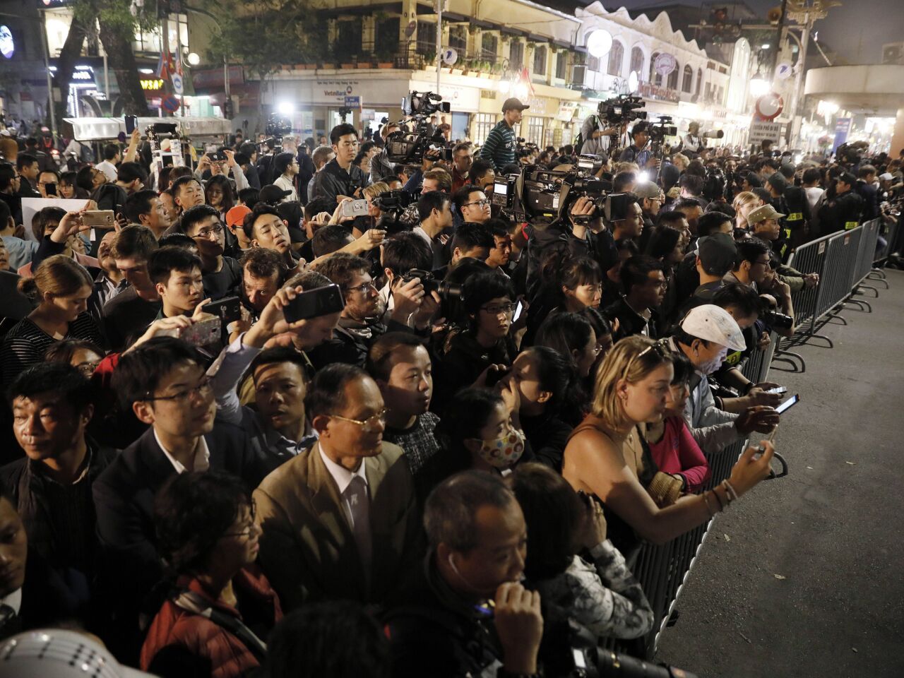 Crowds gather on the streets near the Sofitel Legend Metropole hotel in Hanoi as they wait for President Trump and North Korean leader Kim Jong Un.