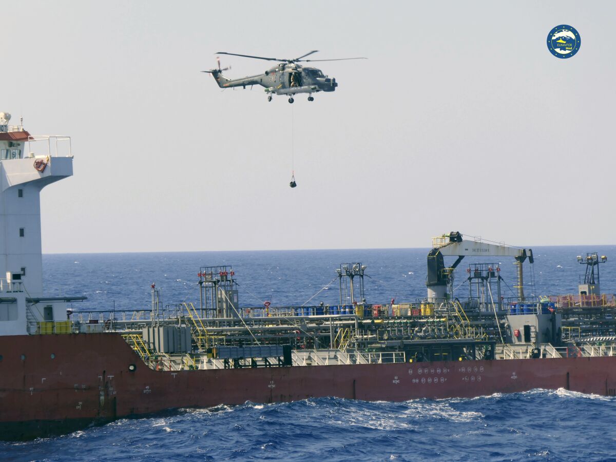 A boarding team board the Merchant Vessel Royal Diamond 7, in international waters, 150 kilometers north of the Libyan city of Derna, Thursday, Sept. 10, 2020. The European Union maritime force enforcing the U.N. arms embargo on Libya said Thursday it re-directed a tanker headed for Libya after determining it contained jet fuel in possible violation of the embargo. The MV Royal Diamond 7 was en route early Thursday from Sharjah, United Arab Emirates to Benghazi, Libya when members of the EU force Operation Irini boarded the ship. (EUNAVFOR Med Irini/Italian Defense Ministry via AP)