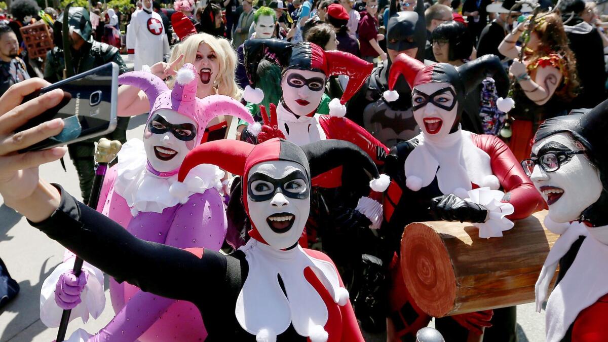Harley Quinns pose for selfies outside the Anaheim Convention Center during WonderCon 2017.