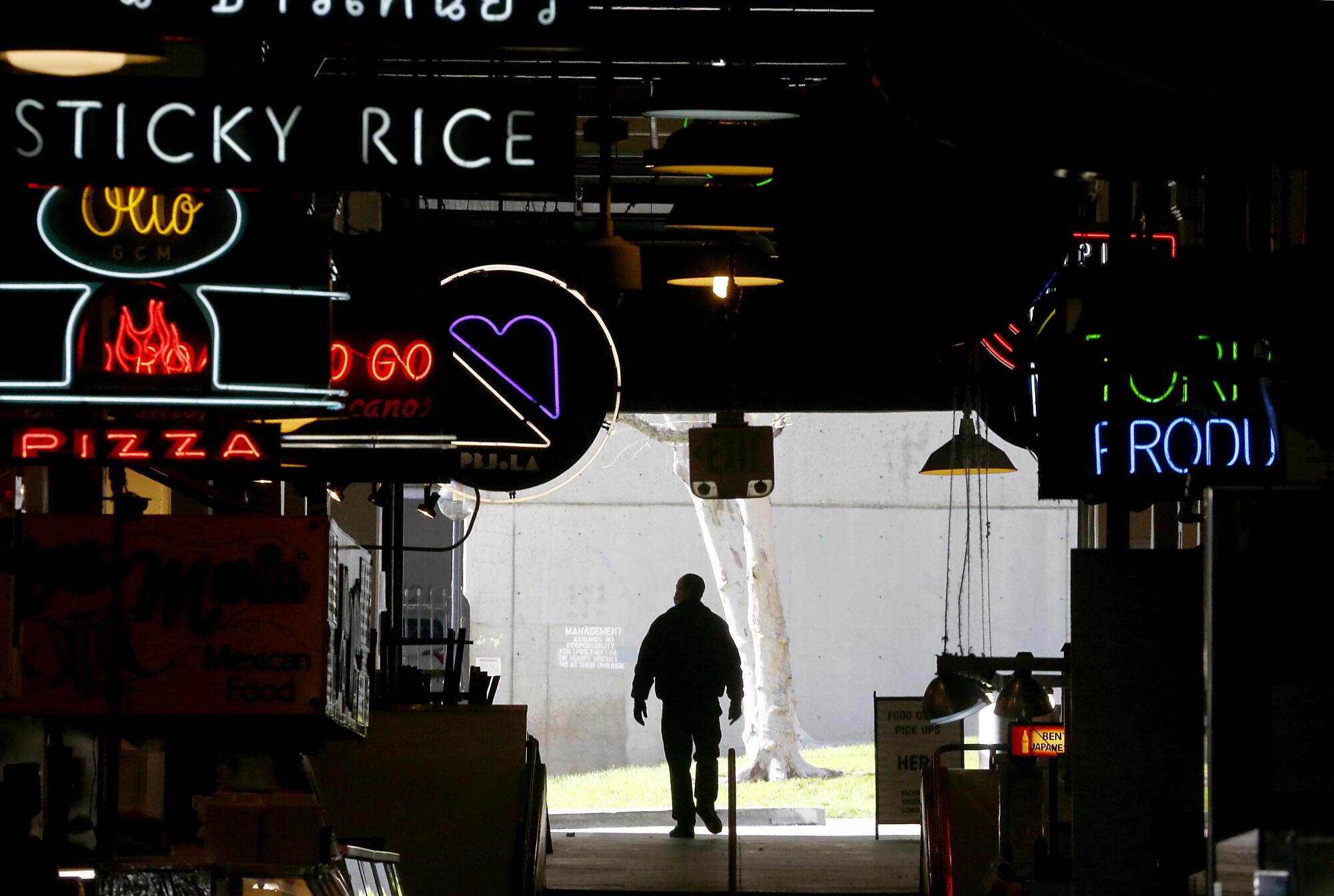 A security guard walks around the Grand Central Market in downtown L.A.