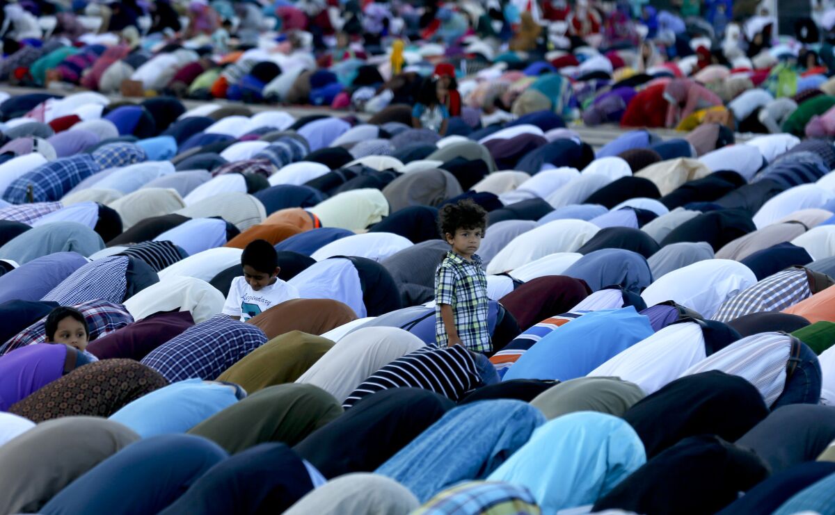 Orange County Muslims gather in prayer in the parking lot of Angel Stadium in Anaheim for Eid al-Adha to mark the end of the annual pilgrimage to Mecca known as Hajj on Sept. 23.