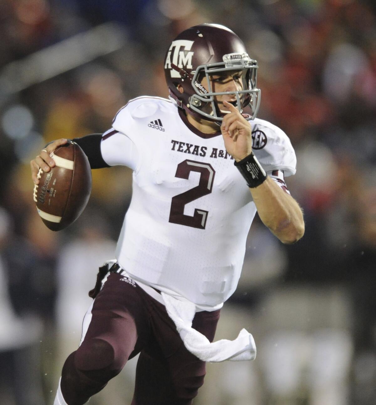 An autograph broker told ESPN that Texas A&M; quarterback Johnny Manziel was paid for signing football helmets.