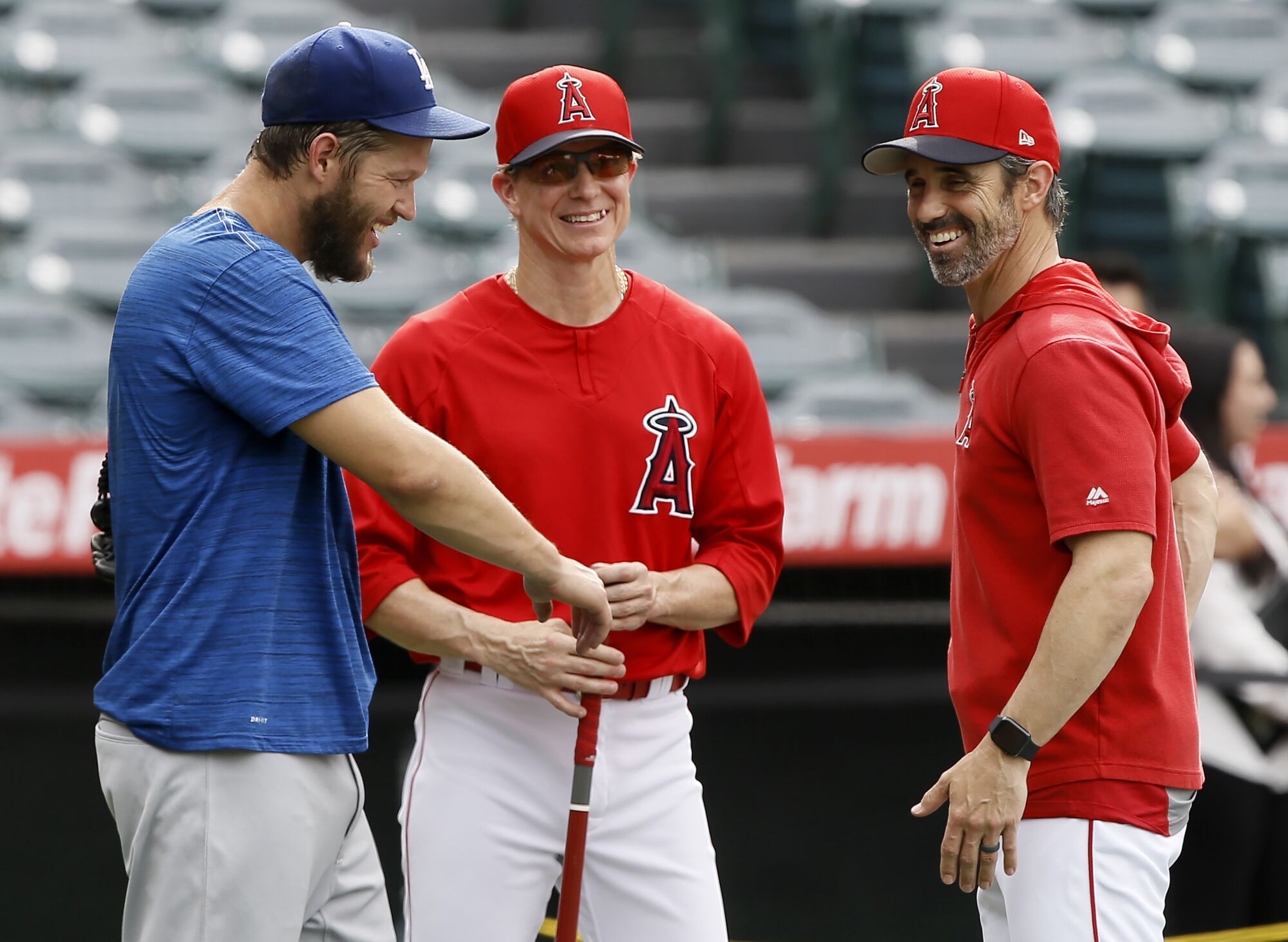 Los Angeles Dodgers starting pitcher Clayton Kershaw, left, talks with Los Angeles Angels manager Brad Ausmus, right.