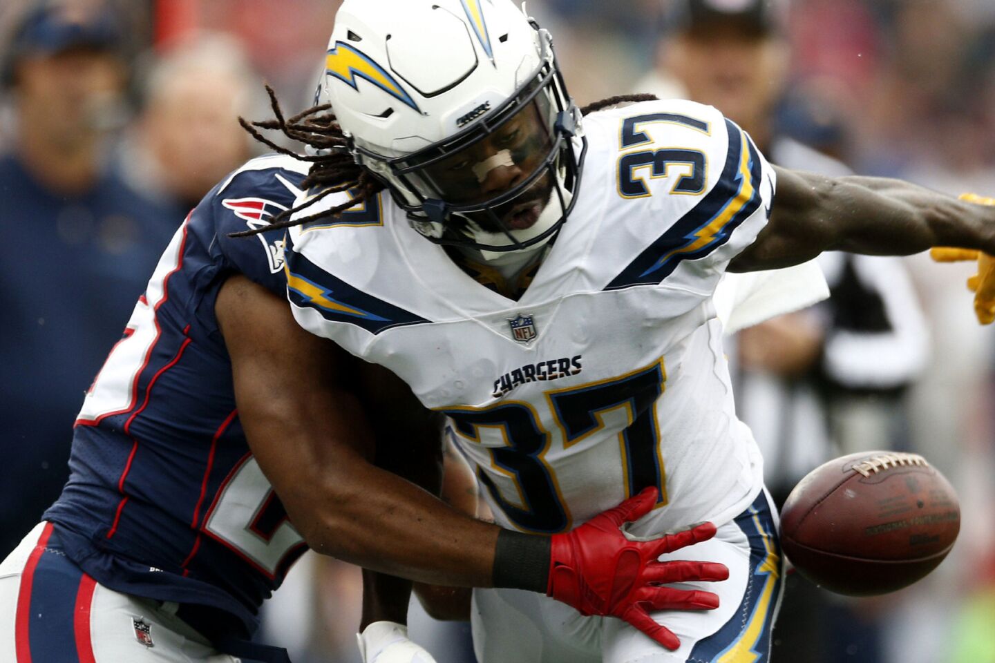 Chargers strong safety Jahleel Addae, right, interferes with a catch attempt by Patriots running back James White during the first half.