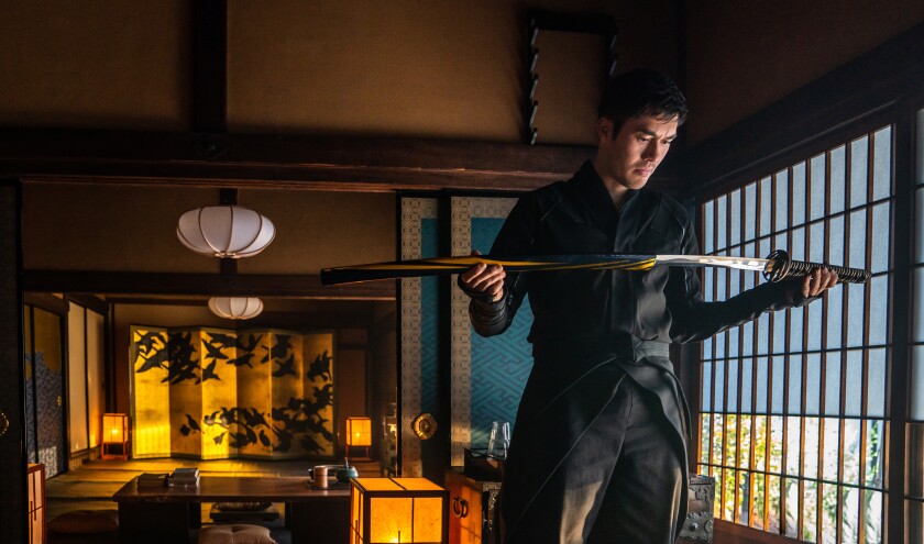 A man unsheathing a sword.