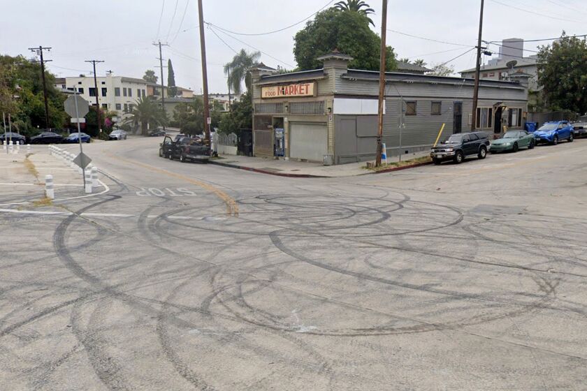 Tire marks from cars doing donuts cover the roadway in front of Bob’s Market in Angelino Heights