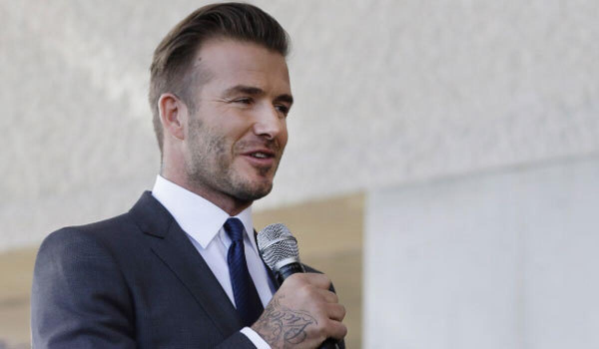 Former Galaxy star David Beckham announces at a news conference Wednesday that he will exercise his option to purchase a Major League Soccer expansion team in Miami.