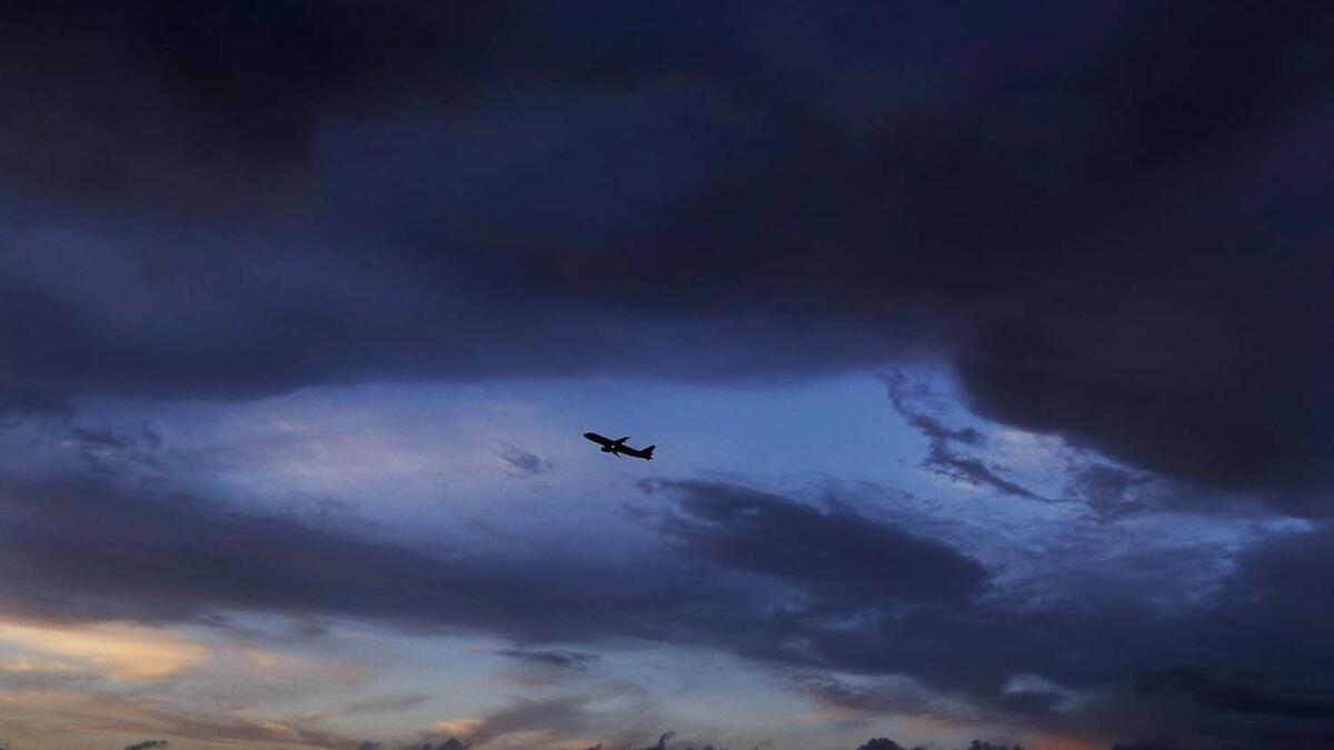 A plane takes off from Los Angeles International Airport under clearing skies after steady rains Thursday.