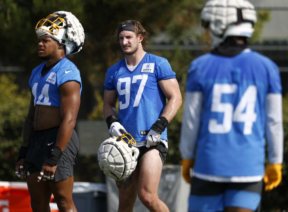 Chargers linebacker Joey Bosa is flanked by Jamal Davis II and Carlo Kemp during practice on Thursday.