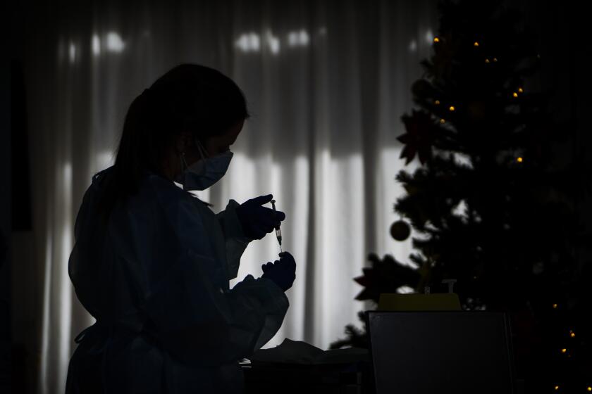 La enfermera Idoia Crespo prepara una vacuna contra el coronavirus en un hogar de ancianos en l'Hospitalet de Llobregat en Barcelona el domingo, 27 de diciembre del 2020. (AP Photo/Emilio Morenatti)