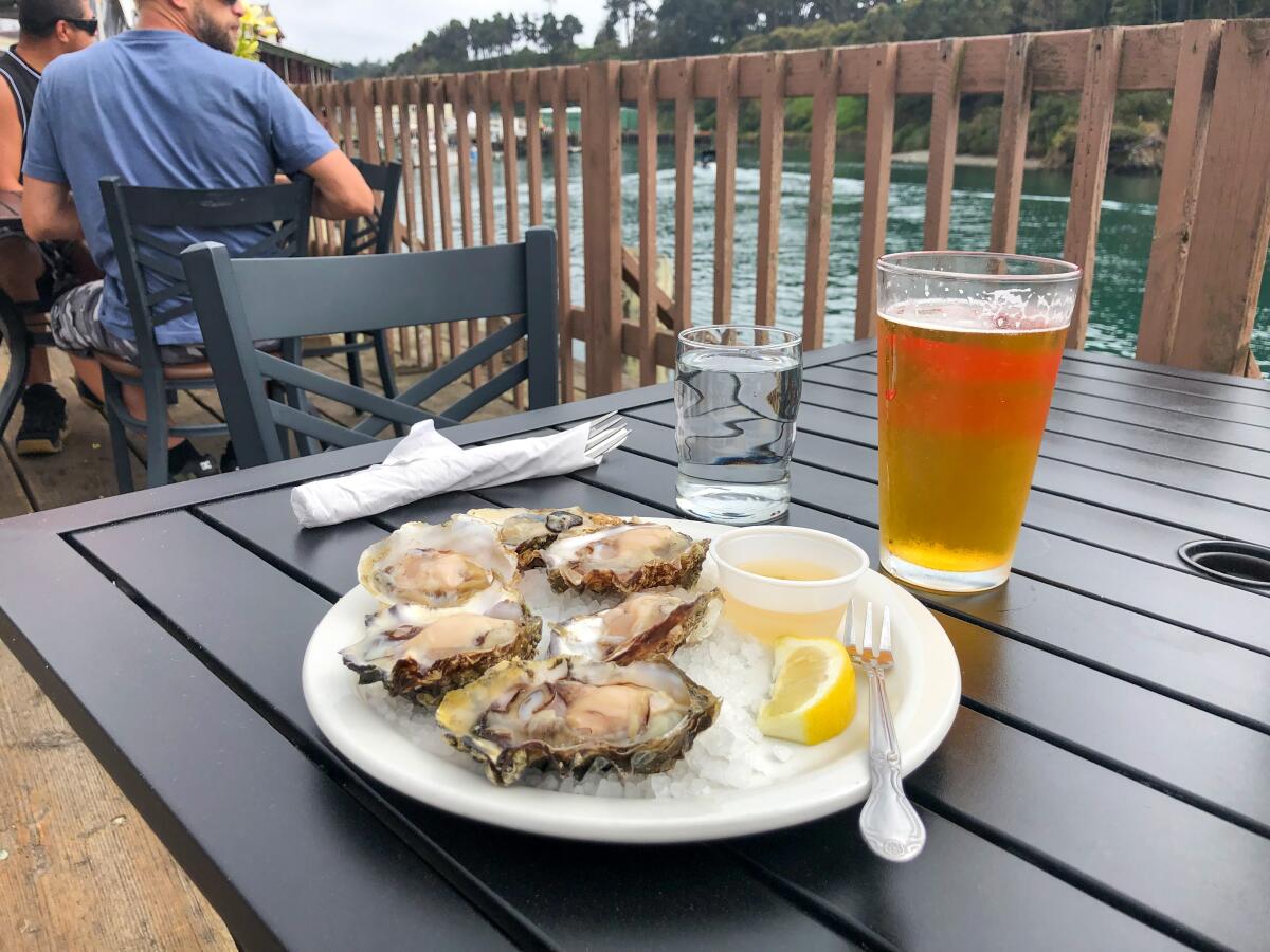 A plate of oysters and a glass of beer on the dining deck at the Noyo River Grill.