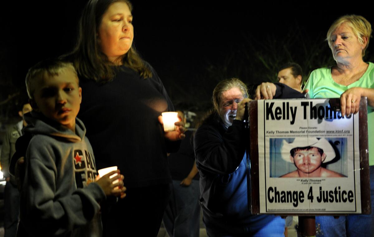 Demonstrators gather Monday night in Fullerton near the site where Kelly Thomas was beaten by police in July 2011. He died five days later.