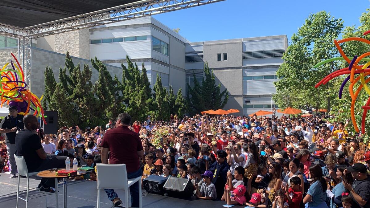 Lakers legend Kobe Bryant, left, speaks during the 2019 Orange County Children's Book Festival.