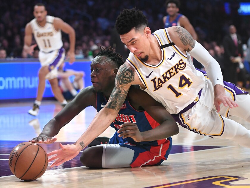 Lakers guard Danny Green and Pistons forward Sekou Doumbouya battle for a loose ball during the second quarter.