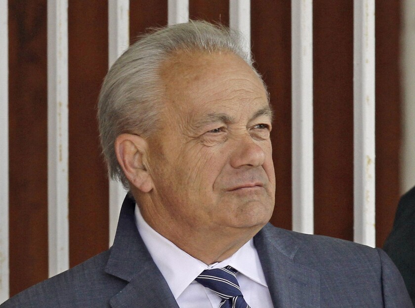 In this March 22, 2014 file photo, horse trainer Jerry Hollendorfer stands in the paddock at Turfway Park in Florence, Ky.