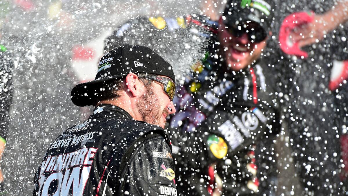 Martin Truex Jr. celebrates with team members after winning the Monster Energy NASCAR Cup Series I Love NY 355 at Watkins Glen International on Sunday.
