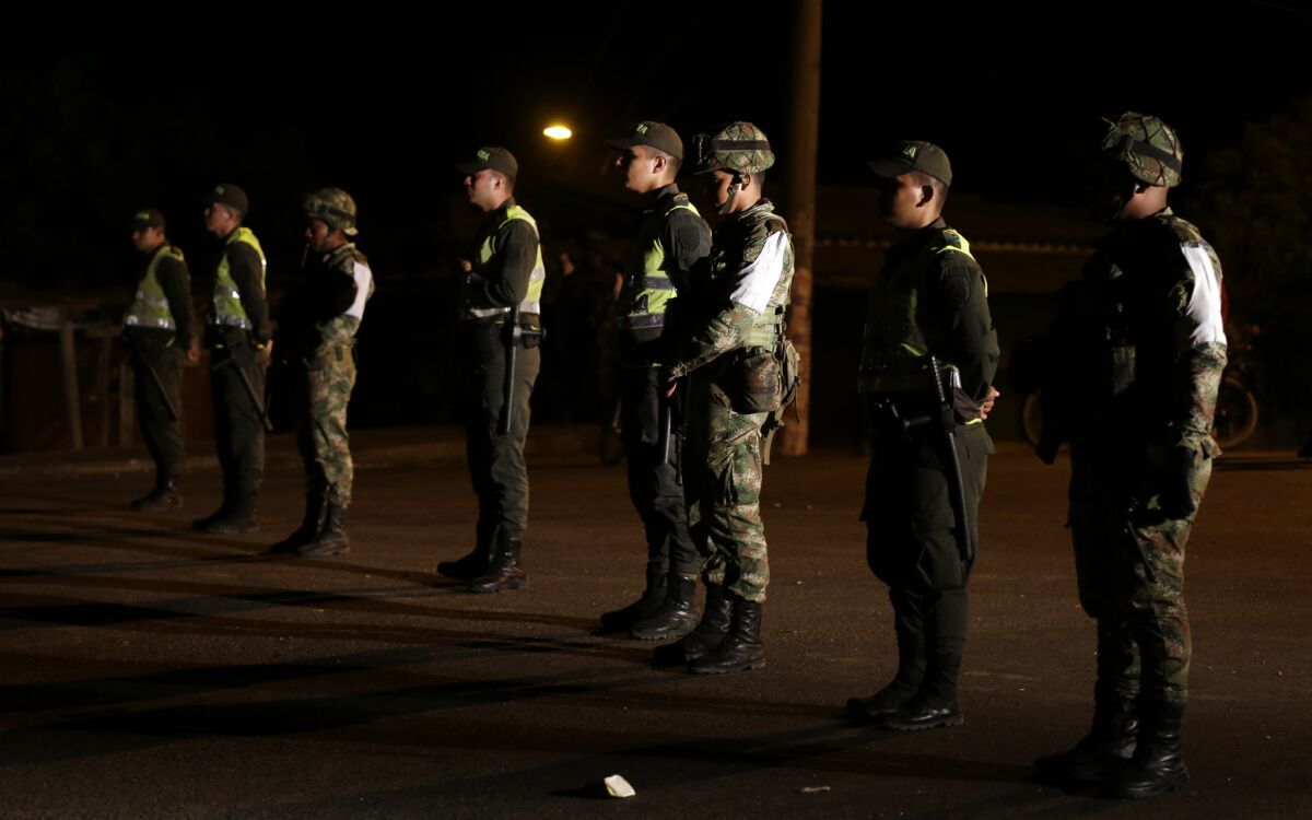 Colombian police officers and soldiers stand guard in the town of Paraguachon along the border with Venezuela on Sept. 8.