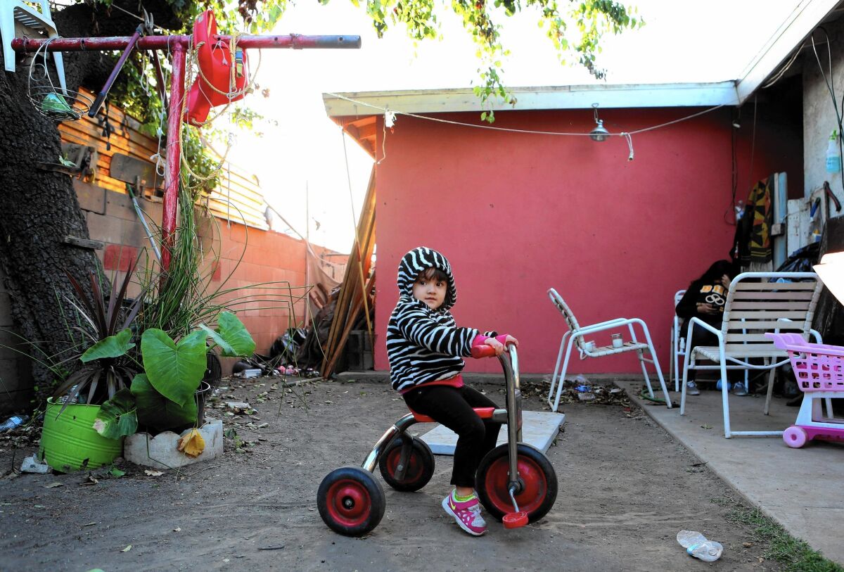 Athena Goytia, 2, plays in the backyard of her family’s home in La Puente. Her mother, Maria, is on paid family leave, but her father, Anthony, had to take another job to make up for the lost income.