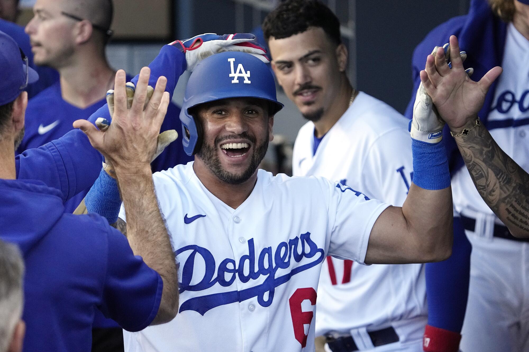 David Peralta celebrates in the dugout after hitting a two-run home run for the Dodgers in the seventh inning.